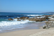 Photo of rocks, surf and sandy beach
